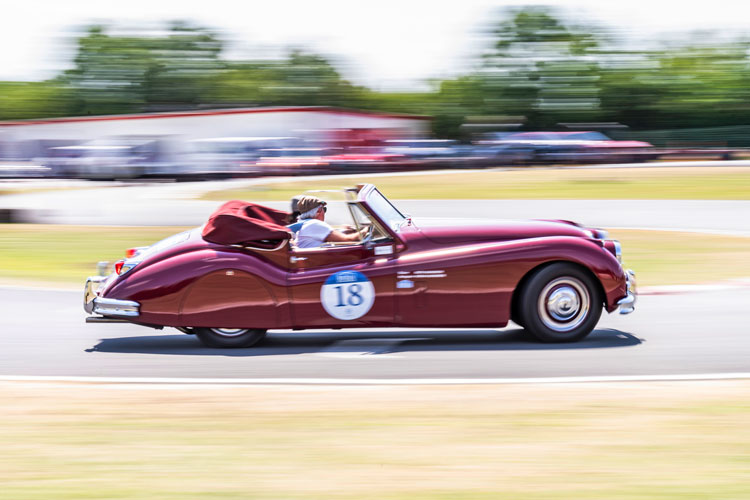 Keith and Norah Ashworth at speed in their 1955 Jaguar XK140 on one of the tests