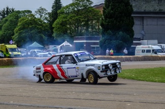 Ford Escort rallycar lifting a wheel at Bicester Heritage