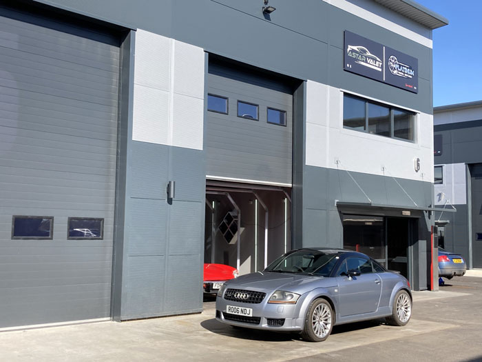 Audi quattro sport parked outside modern industrial unit