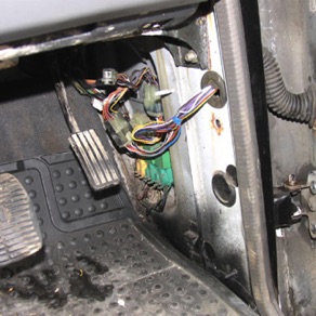 Exposed wires close to throttle pedal