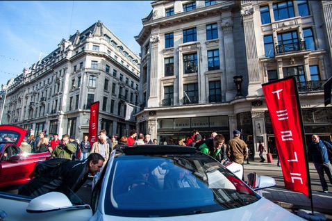 people looking at Tesla cars during the Regents Street Motor Show, London, UK